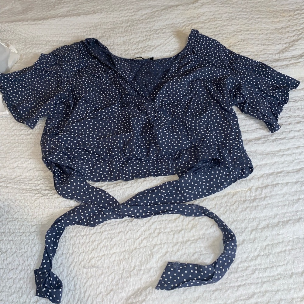 Abercrombie light navy blue and white polka dot top with semi open back.